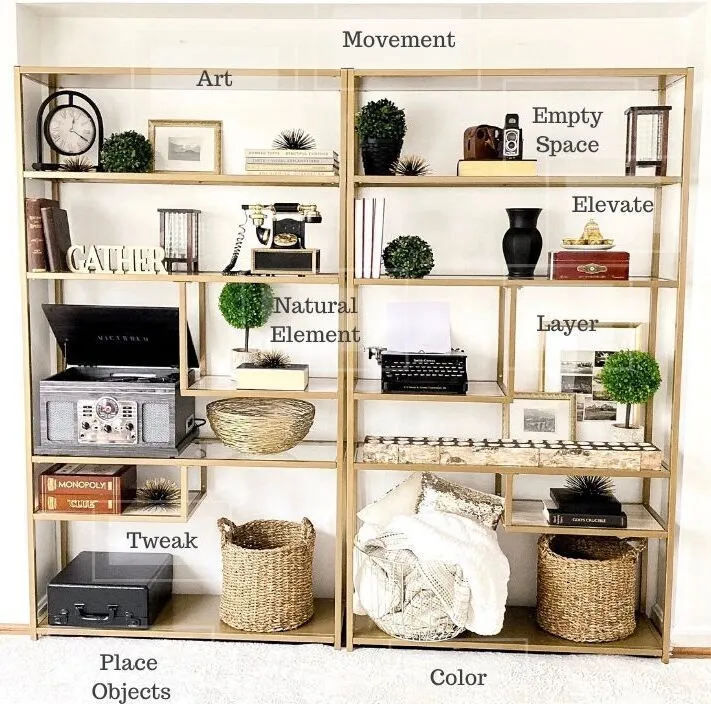 Two tall, gold open shelving units are styled with various decorative objects, including books, plants, a vintage record player, and baskets. Text labels overlay the shelves indicating design principles like 'Art', 'Movement', 'Natural Element', 'Empty Space', 'Elevate', 'Layer', 'Tweak', 'Place Objects', and 'Color'.